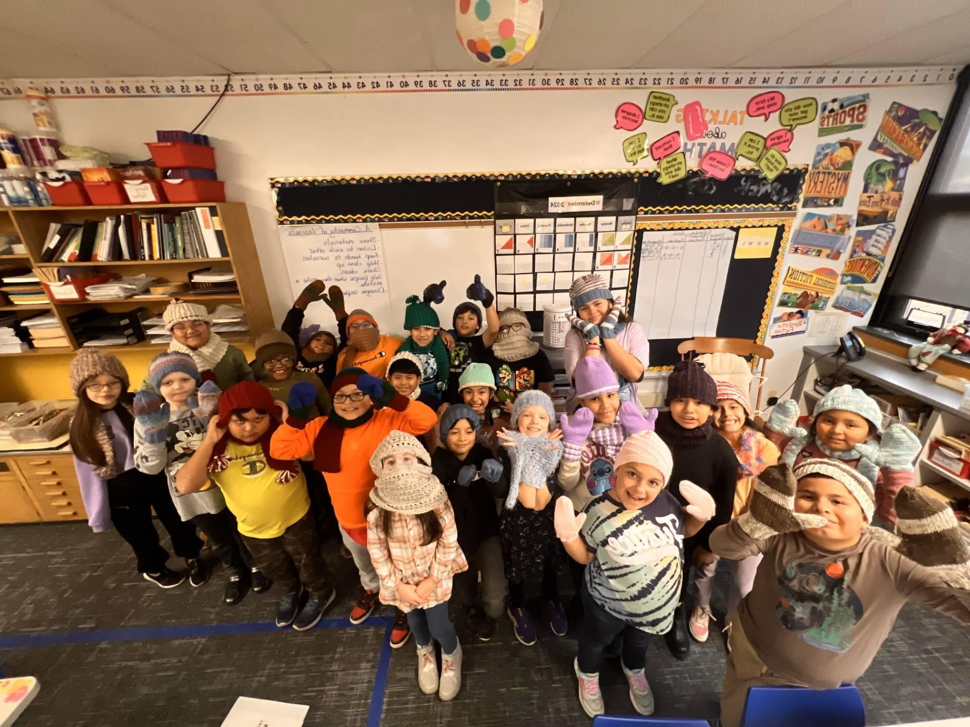 Children at Elementary School wearing their Interfaith and Interwoven knitted items